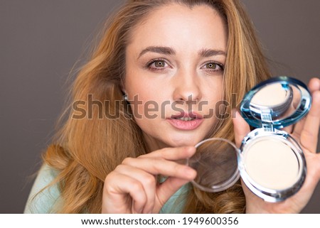 make-up blogger testing decorative cosmetics in front of the camera