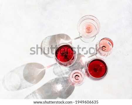 Wine of different varieties on light concrete background. Many different glasses of wine. Wine tasting concept. Top view, flat lay
