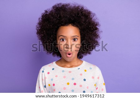 Photo of amazed shocked cute dark skin girl wear white dotted sweater isolated on purple color background