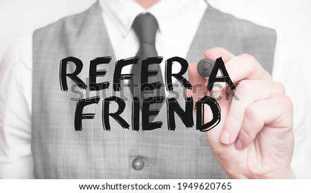Businessman writing word refer a friend with marker, Business concept