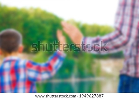 Hands of parent and child in nature in the park travel