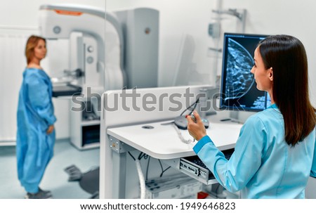 In the hospital, the patient undergoes a screening procedure for a mammogram, which is performed by a mammogram. A modern technologically advanced clinic with professional doctors. Royalty-Free Stock Photo #1949646823
