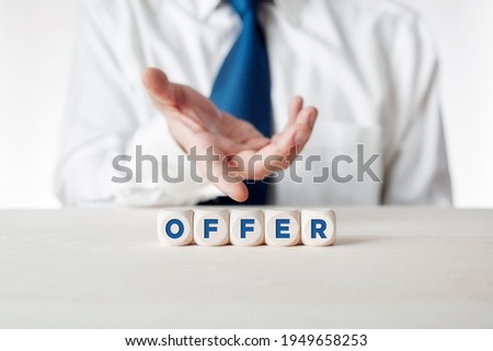Hand of a businessman presenting the wooden cubes with the word offer. Business offer concept.
