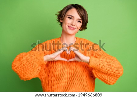Photo of attractive lovely young woman make hands heart shape romantic mood isolated on green color background