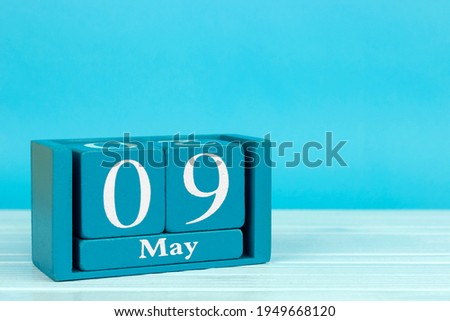wooden calendar with date May 9 on blue wooden background, World Moscato Day