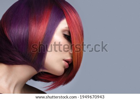 Beautiful woman with multi-colored hair and creative make up and hairstyle. Beauty face.