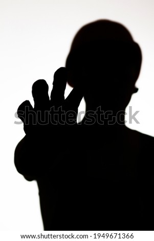 silhouette of builder in hard hat showing palm forbidding gesture stop, warning hand sign,workers protest concept
