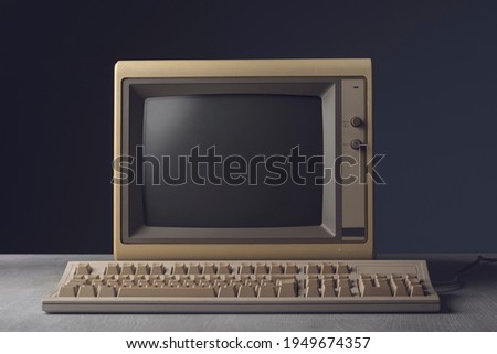 Vintage personal computer with keyboard on a desktop, outdated electronics concept Royalty-Free Stock Photo #1949674357