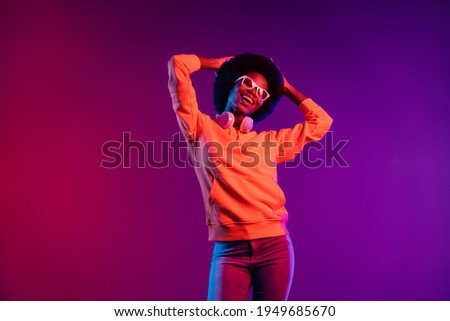 Photo of charming clubber lady dance hands head rejoice wear hoodie earphones specs isolated gradient dark background