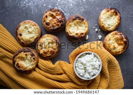 Appetizing round scones with quark. Top view photo of homemade sweet buns made of cottage cheese. Traditional Russian pastries. 