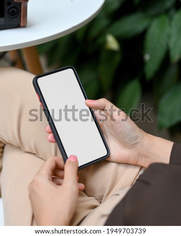 Top view of female hands using smartphone include clipping path screen while relaxed sitting in cafe
