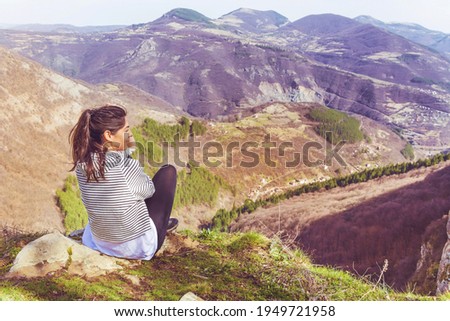 Young Woman Sitting above the  Mountain with Stunning View .Pirin Mountain ,Bulgaria    Royalty-Free Stock Photo #1949721958