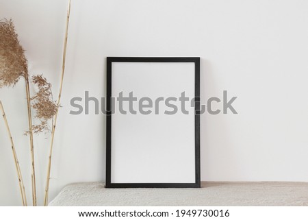 Black photo frame mockup with dry cane
