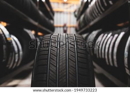A new tire is placed on the tire storage rack in the car workshop. Be prepared for vehicles that need to change tires. Royalty-Free Stock Photo #1949733223