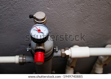 Monometer for determining the water pressure in the heating system. Boiler heating system equipment. Emergency pressure relief valve. Royalty-Free Stock Photo #1949740885