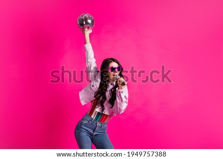 Photo of optimistic brunette lady hold ball sing in mic wear spectacles top jacket isolated on pink color background