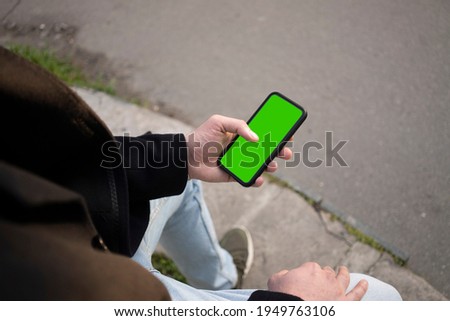 Young man using phone (Green Screen)