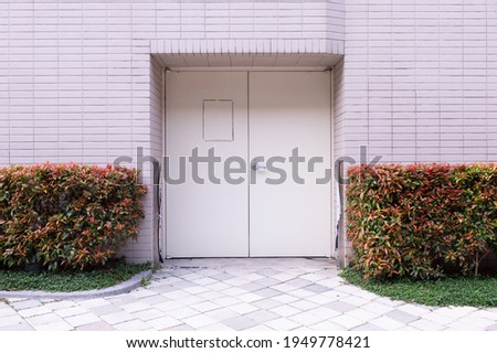 sidewalk by street wall and door