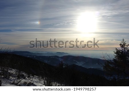 at the summit of Hornisgrinde with a beautiful view of the black forest, snow-covered mountains in Germany 