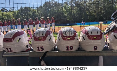 Fast Pitch Softball helmets with the girls on the field.