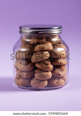 chocolate brown cookies with kinder chocolate in top on purple background 