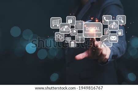 Businessman touching to virtual screen of digital transformation wording and icons, business technology information and innovation concept.