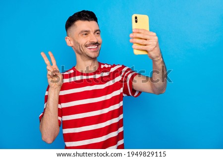 Photo of brunette handsome happy man take selfie make v-sign isolated on pastel blue color background