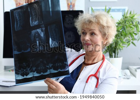 Elderly doctor woman is holding x-ray closeup