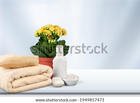 Soft light bathroom decor, towel, soap with flowers, accessories on desk