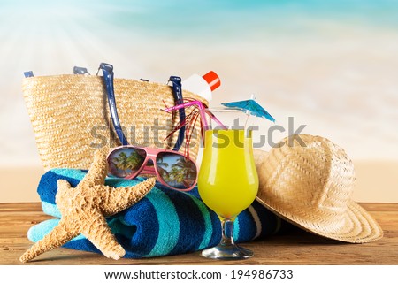 Close-up of summer accessories on sandy beach.
