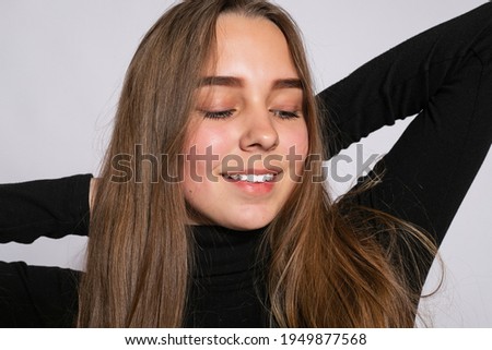 Trendy beautiful hipster girl. Photo of positive young nice woman in black knee-high socks with white background. looking at the camera and smiling
