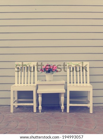 Vintage wood chairs with flower decoration outdoor