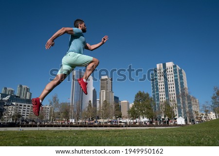 Athlete runner feet running in city park. Jogging concept at outdoors. Man running for exercise on City background
