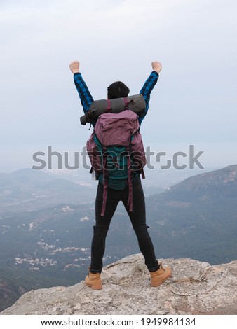 young man with backpack in the mountain