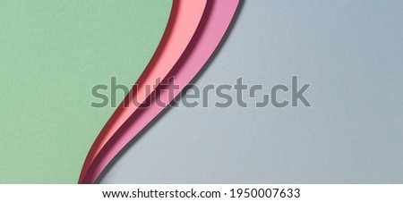 Abstract geometric paper texture banner background. Blue green purple pink waves and curved lines papercut composition. Top view Royalty-Free Stock Photo #1950007633