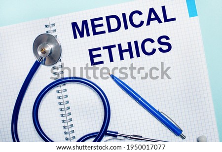 On a light blue background, an open notebook with the words MEDICAL ETHICS, a blue pen and a stethoscope. View from above. Medical concept