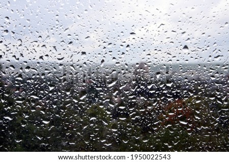 Beautiful rain drops on the window with nature outside