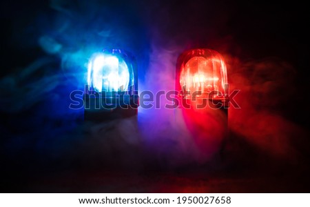Police car blue and red round vintage siren in dark. Rotating retro style police siren. Selective focus Royalty-Free Stock Photo #1950027658