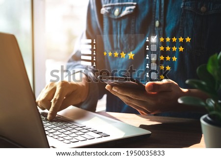 User give rating to service experience on online application, Customer review satisfaction feedback survey concept, Customer can evaluate quality of service leading to reputation ranking of business. Royalty-Free Stock Photo #1950035833