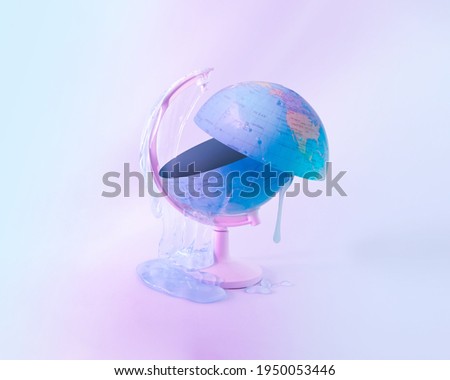 Halved globe with slime on pastel purple-blue-pink, holographic, iridescent, neon, background. Idea of dangers of climate change. Minimal creative concept of global warming or environmental pollution.