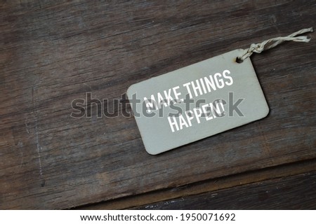 Wooden board written with text MAKE THINGS HAPPEN!