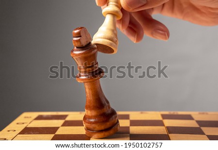 Business strategy concept. Knight making final last step to make checkmate in chess, falling king. Royalty-Free Stock Photo #1950102757