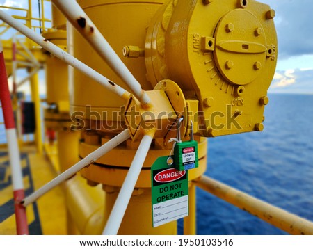 The photo is key lock with tag for isolated valve. Royalty-Free Stock Photo #1950103546
