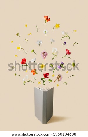 Colorful flowers (Freesia, Button Pom Chrysanthemum, Elephant's Ears, Golden Bell, Peruvian lily, Daffodil and Daisies) coming out of open grey book on pastel yellow background.Minimal nature concept.
