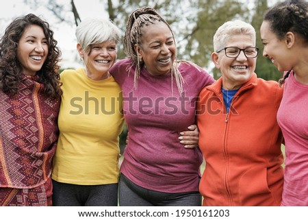Multi generational women hugging each other at park - Multiracial people having fun outdoor Royalty-Free Stock Photo #1950161203