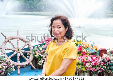 Asian woman posing in beautiful park behind Senayan Park Mall Jakarta, Indonesia where people go and take their own pictures