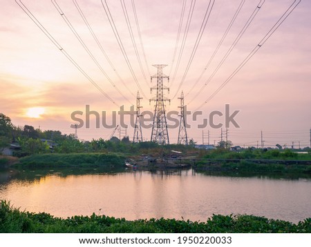 high angle view of high voltage transmission towers with power line over twilight sky background the electricity infrastructure from power plant to industrial and household with morning dawn light