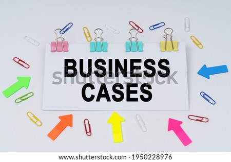 Business and finance concept. On the table there are paper clips and directional arrows, a sign that says - BUSINESS CASES