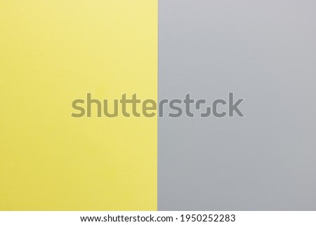 Flat lay. Top view blank yellow and gray paper background with copy space. Trendy theme of color of the year 2021. Ultimate gray and Illuminating. Color paper background.