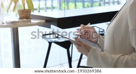 Business woman working with stylus pen on pro digital tablet with graphics design diagram 